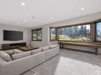Experience luxury living in this stunning property! This home boasts a spacious living area with a large TV and a comfortable sofa, perfect for relaxation.