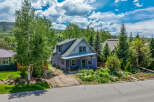 Charming purple home nestled amongst mature trees and vibrant gardens.