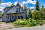 Charming mountain home featuring a vibrant purple exterior and a welcoming covered porch.