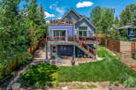 Discover this charming multi-level home featuring a vibrant purple exterior and multiple decks perfect for outdoor living.