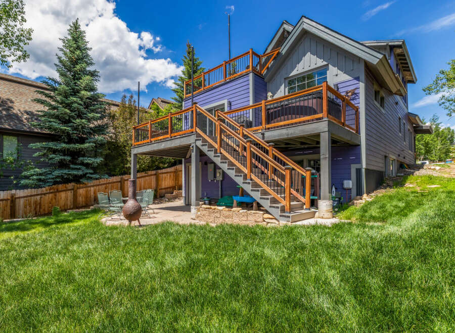 Enjoy outdoor living with this multi-level deck featuring a hot tub and ample space for entertaining.