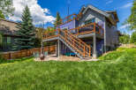 Enjoy outdoor living with this multi-level deck featuring a hot tub and ample space for entertaining.