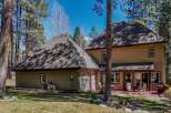 Nestled amidst towering trees, this stunning property boasts a spacious layout and inviting outdoor spaces.