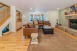 Step into luxury with this stunning living room, featuring a cozy sectional sofa and a beautiful stone fireplace.