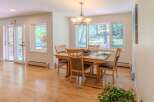 This inviting dining room features a beautiful wooden table and chairs, perfect for family gatherings.