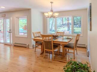 This inviting dining room features a beautiful wooden table and chairs, perfect for family gatherings.