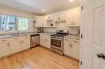 This stunning kitchen boasts bright white cabinetry, offering a clean and modern aesthetic.