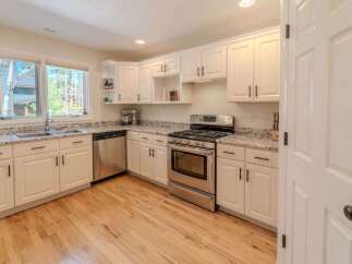 This stunning kitchen boasts bright white cabinetry, offering a clean and modern aesthetic.