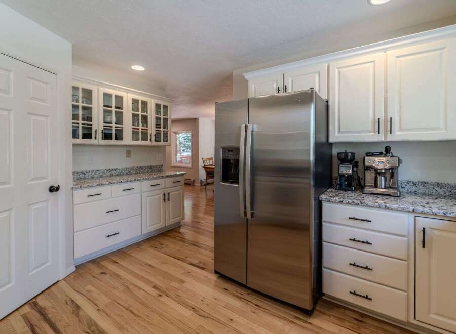 Step into this stunning kitchen, featuring sleek stainless steel appliances and ample cabinet space.