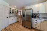 Step into this stunning kitchen, featuring sleek stainless steel appliances and ample cabinet space.