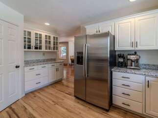 Step into this stunning kitchen, featuring sleek stainless steel appliances and ample cabinet space.