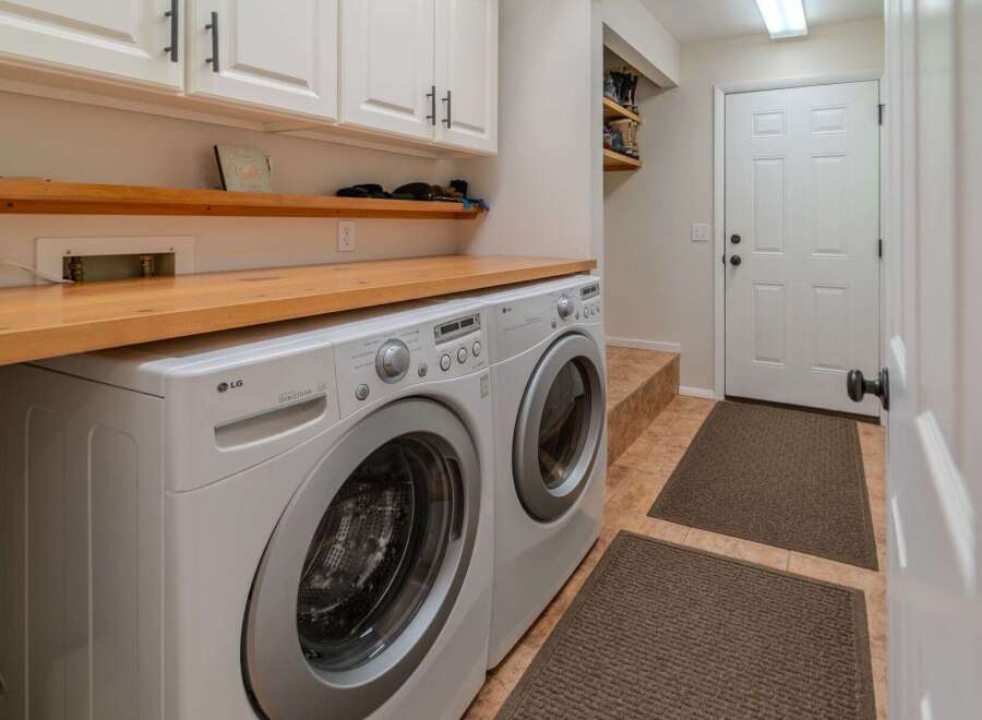 This laundry room boasts modern convenience and style.