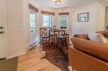 Step into this inviting space, featuring a cozy dining area with a charming round table and stylish bar stools.