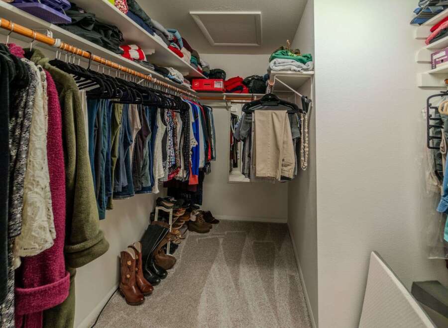 Step into this well-organized walk-in closet, a dream for any homeowner.