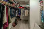 Step into this well-organized walk-in closet, a dream for any homeowner.