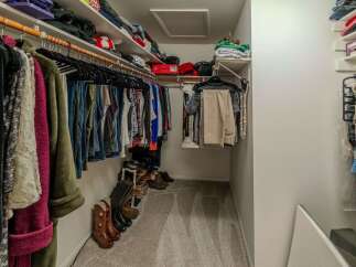 Step into this well-organized walk-in closet, a dream for any homeowner.