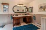 This stunning bathroom boasts a luxurious double vanity with ample storage and a sleek design.