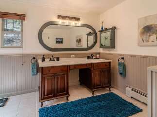 This stunning bathroom boasts a luxurious double vanity with ample storage and a sleek design.