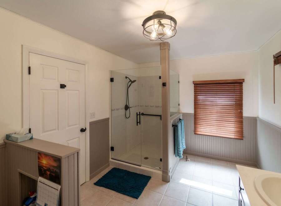 Step into this beautifully designed bathroom featuring a modern glass shower, perfect for a relaxing experience.