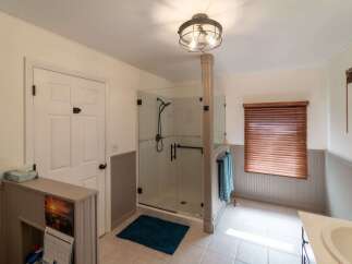 Step into this beautifully designed bathroom featuring a modern glass shower, perfect for a relaxing experience.