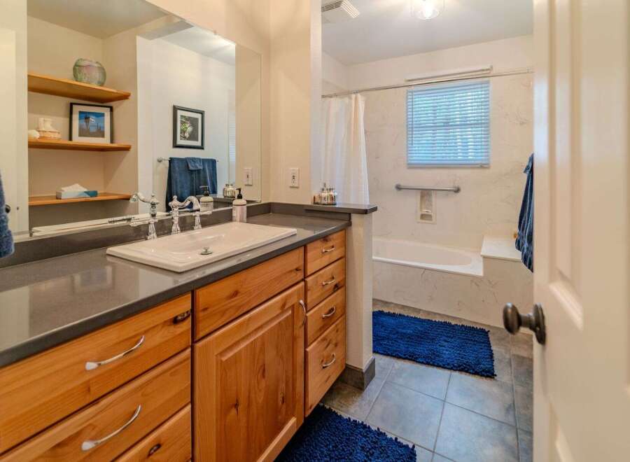Step into this beautifully designed bathroom featuring a stylish vanity with ample storage.