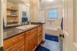 Step into this beautifully designed bathroom featuring a stylish vanity with ample storage.