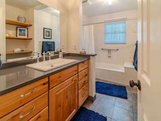 Step into this beautifully designed bathroom featuring a stylish vanity with ample storage.