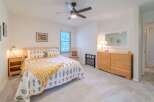 This inviting bedroom boasts a cozy atmosphere with its plush carpet and natural light.