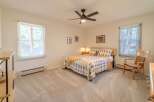 This inviting bedroom features a cozy queen-sized bed with stylish bedding, perfect for a restful night's sleep.