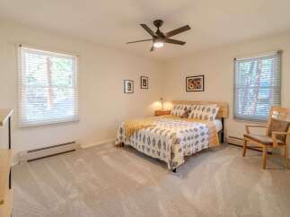 This inviting bedroom features a cozy queen-sized bed with stylish bedding, perfect for a restful night's sleep.