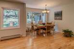 This inviting dining room features a beautiful hardwood floor and a stylish chandelier, creating a warm and welcoming atmosphere.