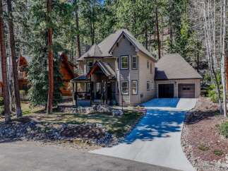 Nestled in a serene, wooded setting, this stunning property boasts a charming two-story home with a welcoming porch.