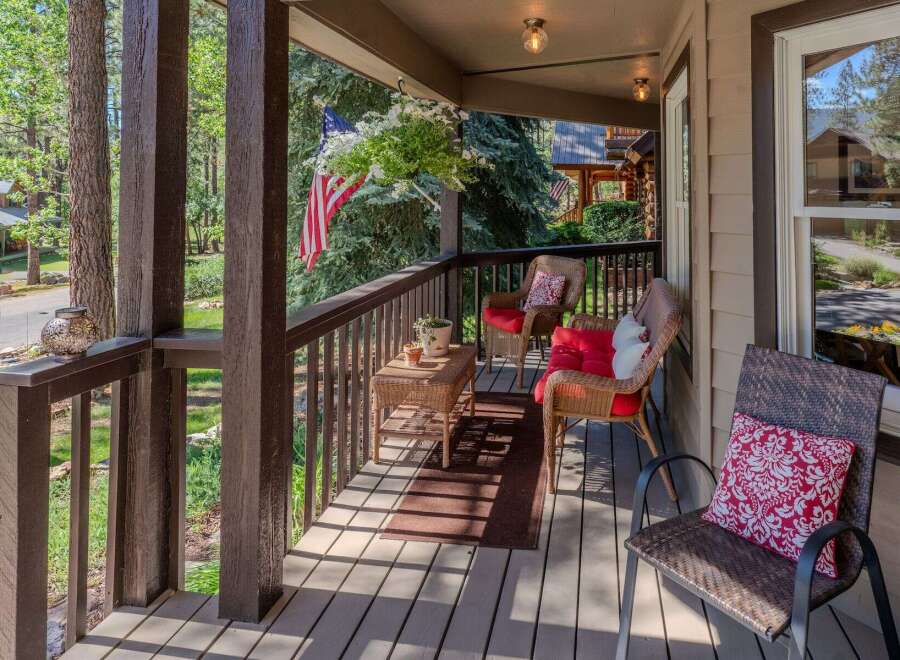 Enjoy the serene mountain lifestyle from this charming covered porch, perfect for relaxing with a morning coffee or evening drink.