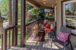Enjoy the serene mountain lifestyle from this charming covered porch, perfect for relaxing with a morning coffee or evening drink.