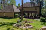 Enjoy outdoor living in this spacious backyard featuring a large wooden deck perfect for entertaining.