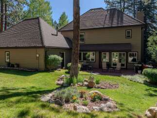Enjoy outdoor living in this spacious backyard featuring a large wooden deck perfect for entertaining.