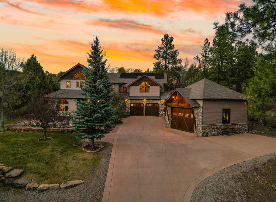 This stunning property boasts a beautiful exterior with a spacious driveway and a well-manicured lawn.