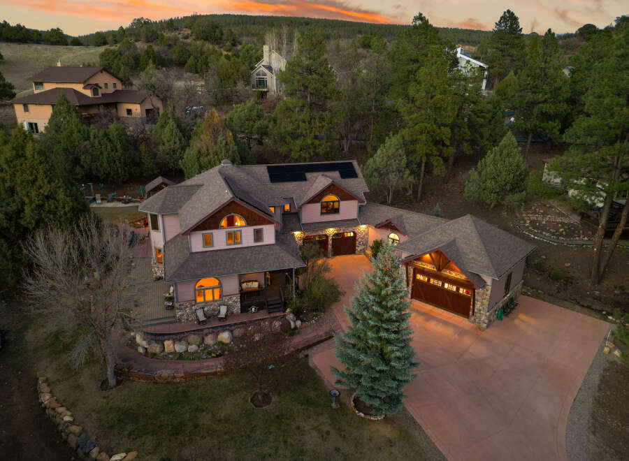This stunning property boasts a luxurious multi-car garage and a beautifully landscaped yard, perfect for outdoor enjoyment.