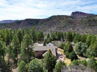 Nestled amidst lush greenery and majestic mountains, this stunning property offers a serene escape.