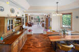 Step into this inviting dining room, showcasing a stunning live-edge wooden table and stylish chairs.