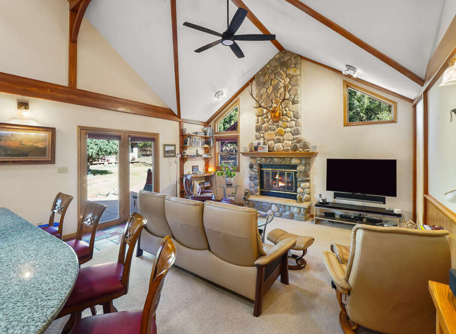 This stunning property boasts a cozy living room with a stone fireplace, perfect for those chilly evenings.