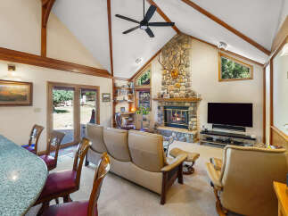 This stunning property boasts a cozy living room with a stone fireplace, perfect for those chilly evenings.