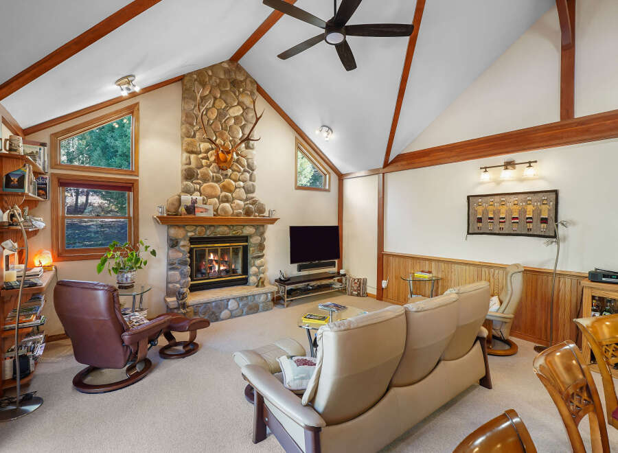 Step into luxury with this stunning property featuring a cozy stone fireplace, perfect for chilly evenings.