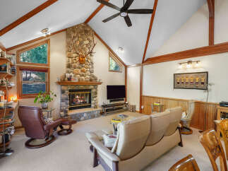 Step into luxury with this stunning property featuring a cozy stone fireplace, perfect for chilly evenings.