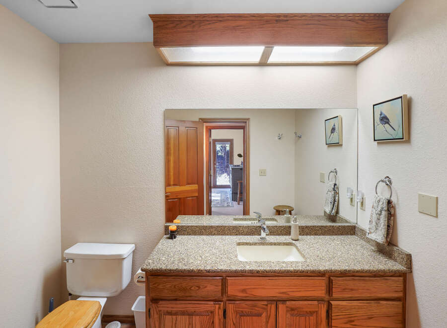 This charming bathroom boasts a warm and inviting ambiance, perfect for relaxation.
