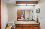 This charming bathroom boasts a warm and inviting ambiance, perfect for relaxation.