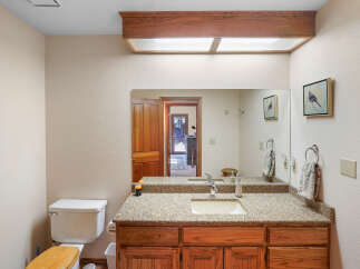 This charming bathroom boasts a warm and inviting ambiance, perfect for relaxation.