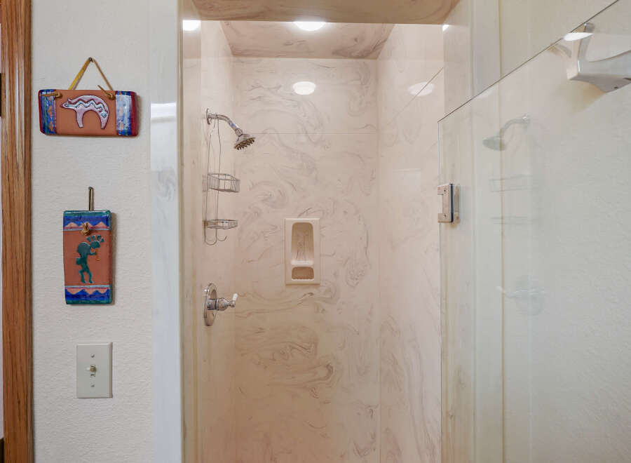 Step into a beautifully designed bathroom featuring a stylish shower with a glass door.