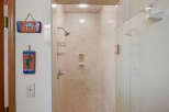Step into a beautifully designed bathroom featuring a stylish shower with a glass door.