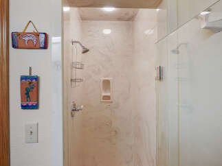 Step into a beautifully designed bathroom featuring a stylish shower with a glass door.